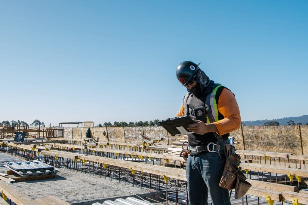 A construction worker using Bluebeam Revu on a construction site - Bluebeam Project Handover