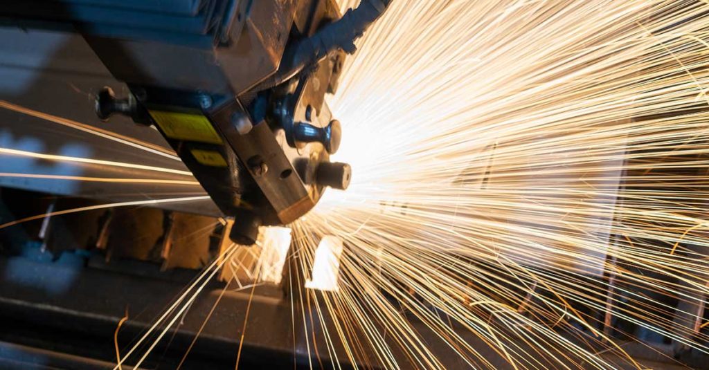 Robotic arm welding on a manufacturing line.