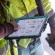 Construction workers using Autodesk on a tablet