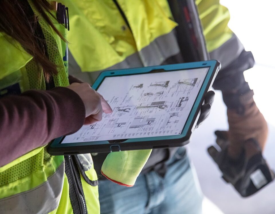 Construction workers using Autodesk on a tablet