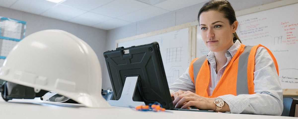 A female construction worker on a computer