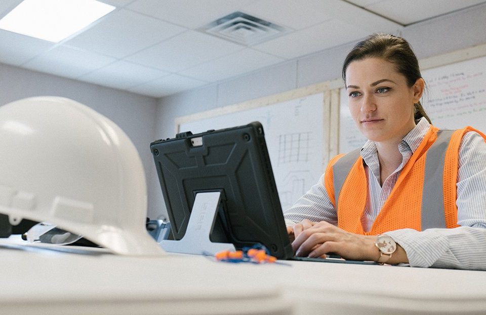 A female construction worker on a computer